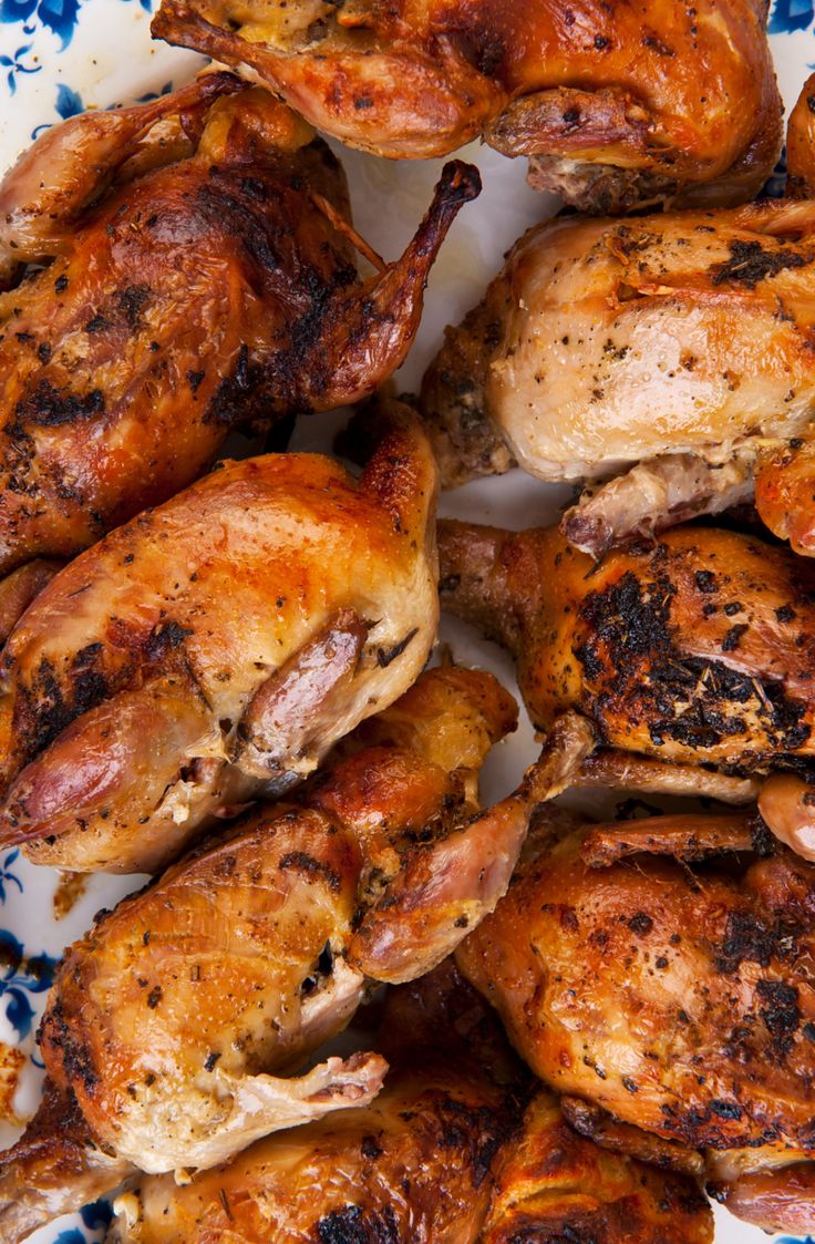 several whole chickens on a blue and white plate