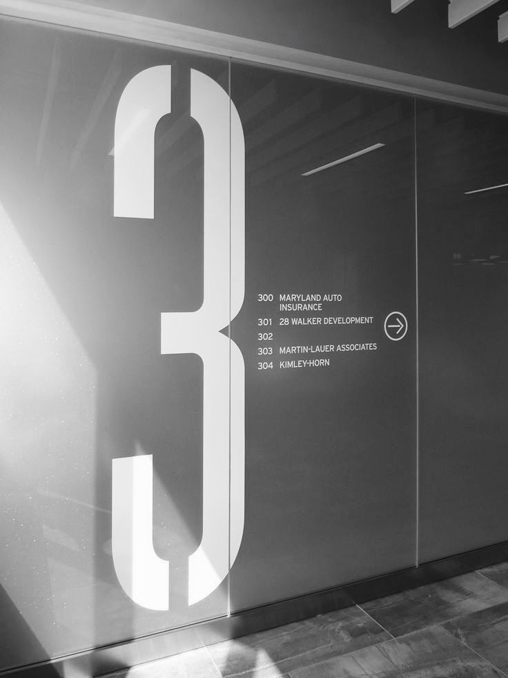 the number 3 is etched on glass to give it an interesting look in this building's entrance