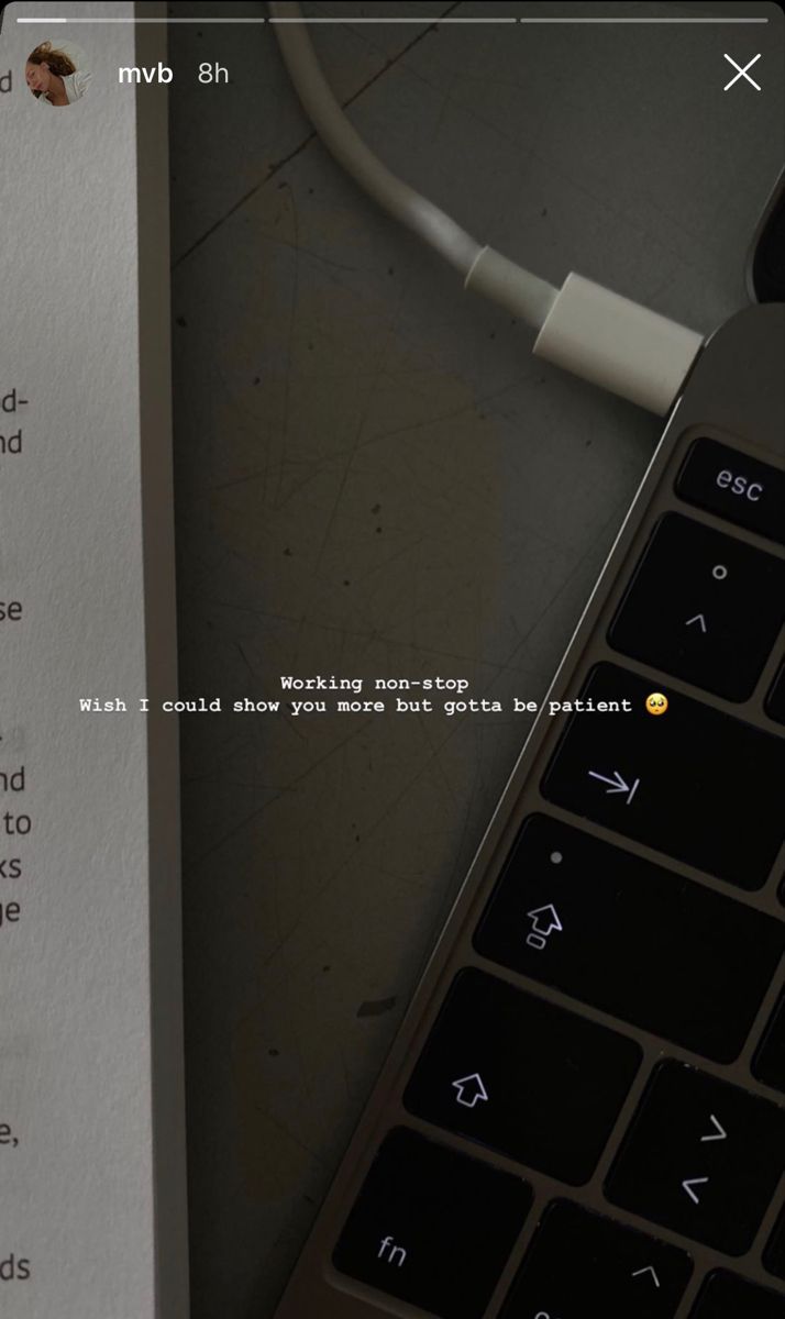 a computer keyboard sitting on top of a table next to a piece of paper with writing on it