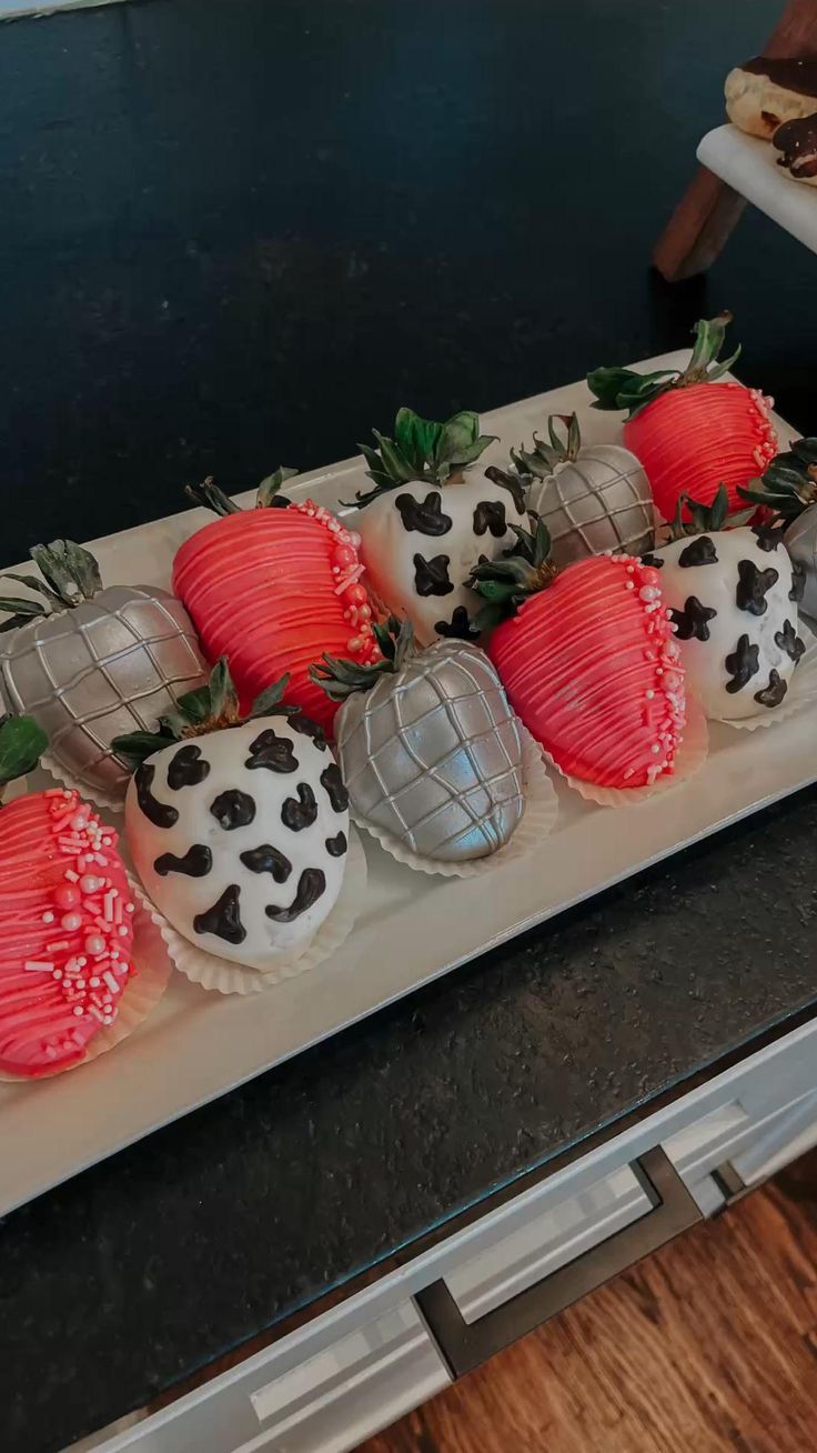 there is a plate with chocolate covered strawberries on it