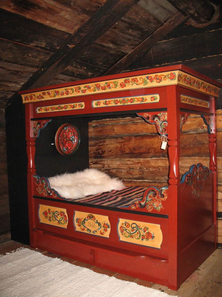 a bed made out of wood and painted red