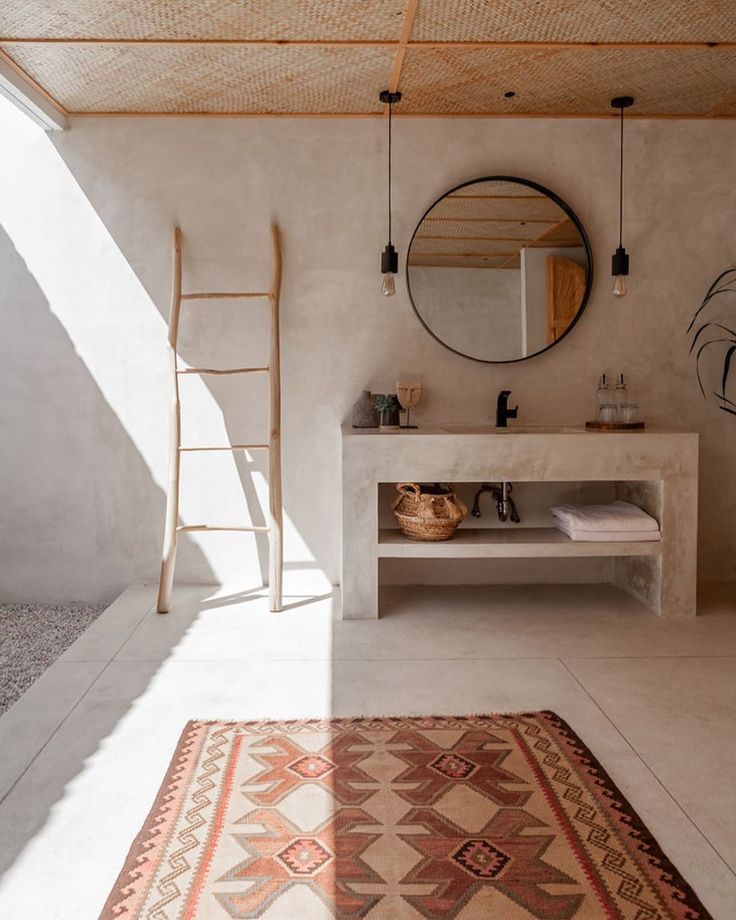 a bathroom with a rug, mirror and ladder in it's centerpieces