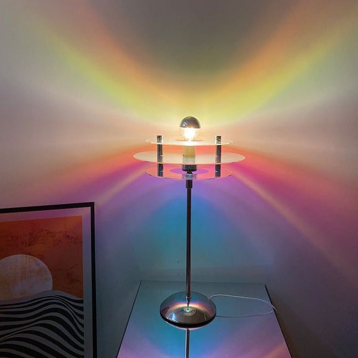 a lamp that is sitting on top of a glass table in front of a painting