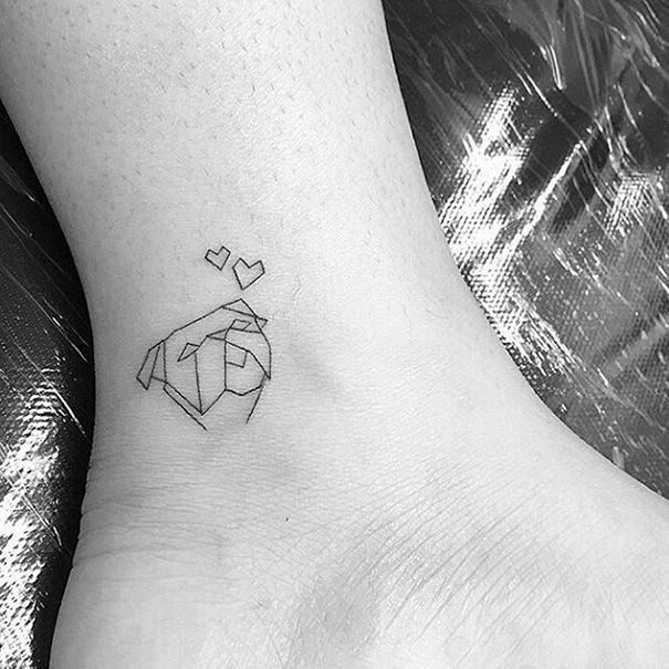 a small black and white tattoo on the ankle