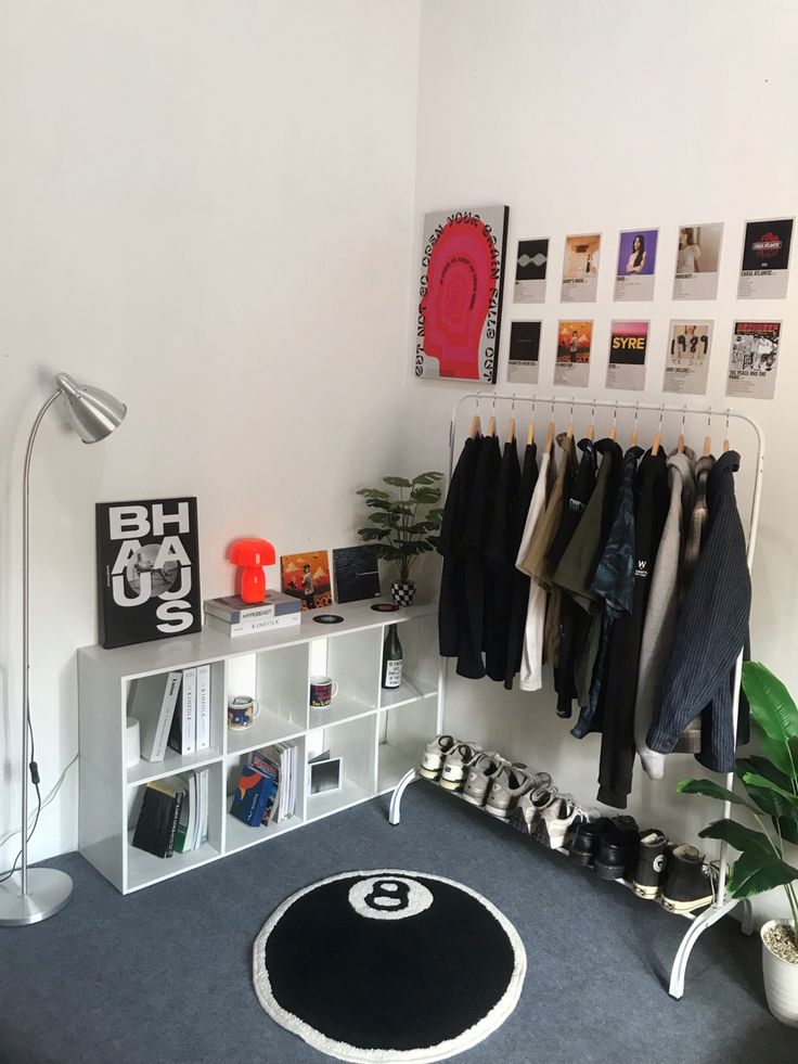 a room that has some clothes hanging on the wall and a rug in front of it