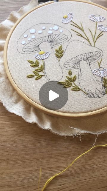 a close up of a embroidery project on a table