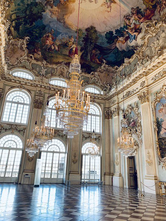 an ornate room with chandeliers and paintings on the ceiling