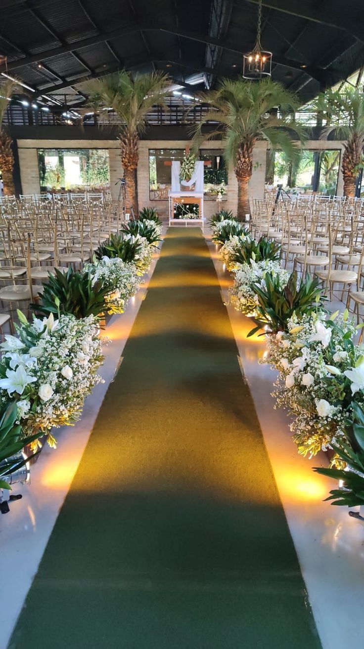 the aisle is lined with chairs and flowers