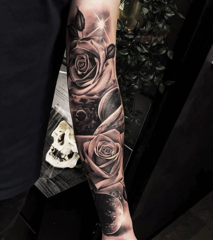 a man's arm with roses on it