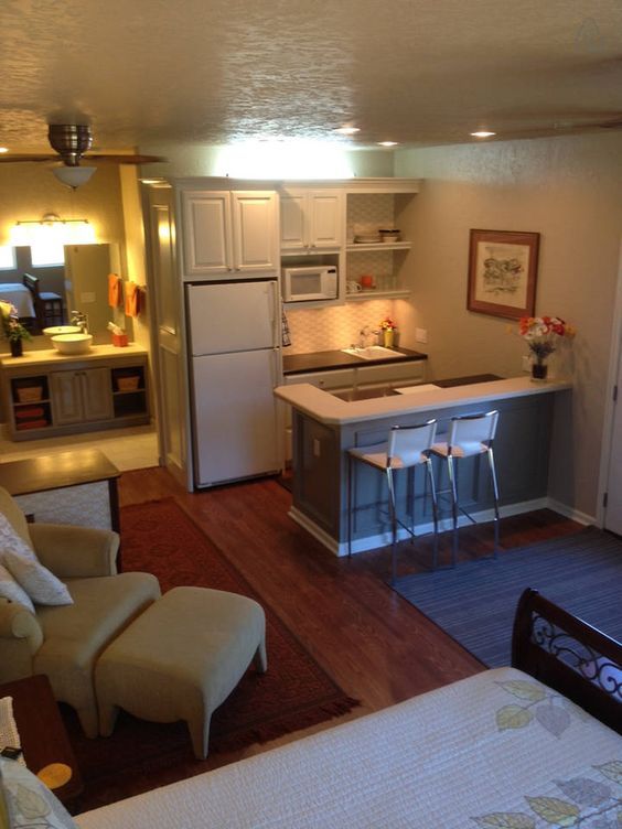 a kitchen and living room are shown in this view from the doorway to the bedroom