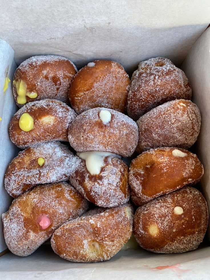 a box filled with donuts covered in powdered sugar