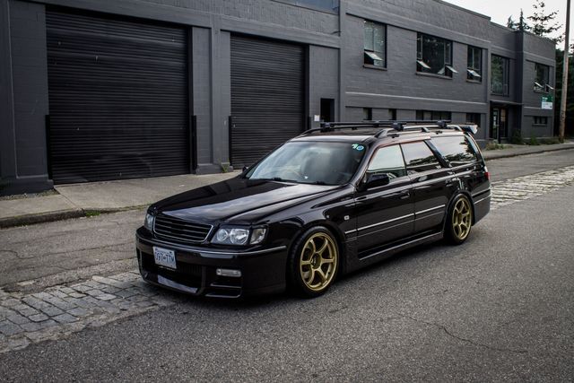 a black car is parked on the street