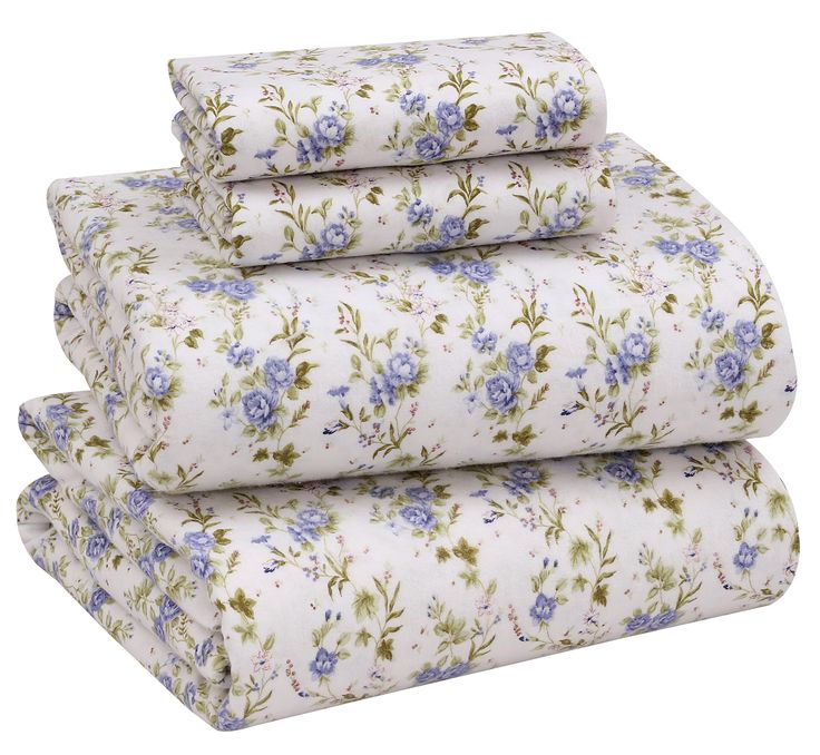 four sheets with blue flowers on them are stacked up in front of eachother