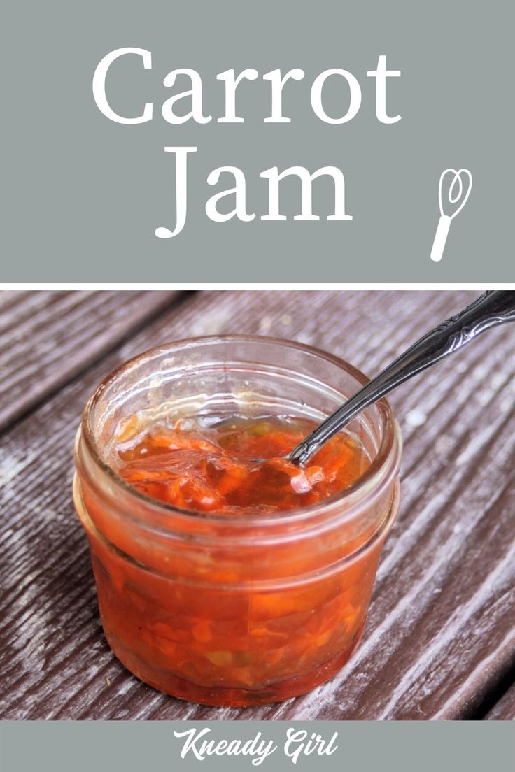 a jar filled with carrot jam sitting on top of a wooden table