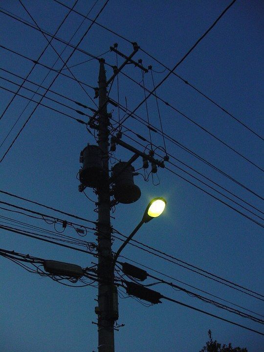 an electric pole and street light at night