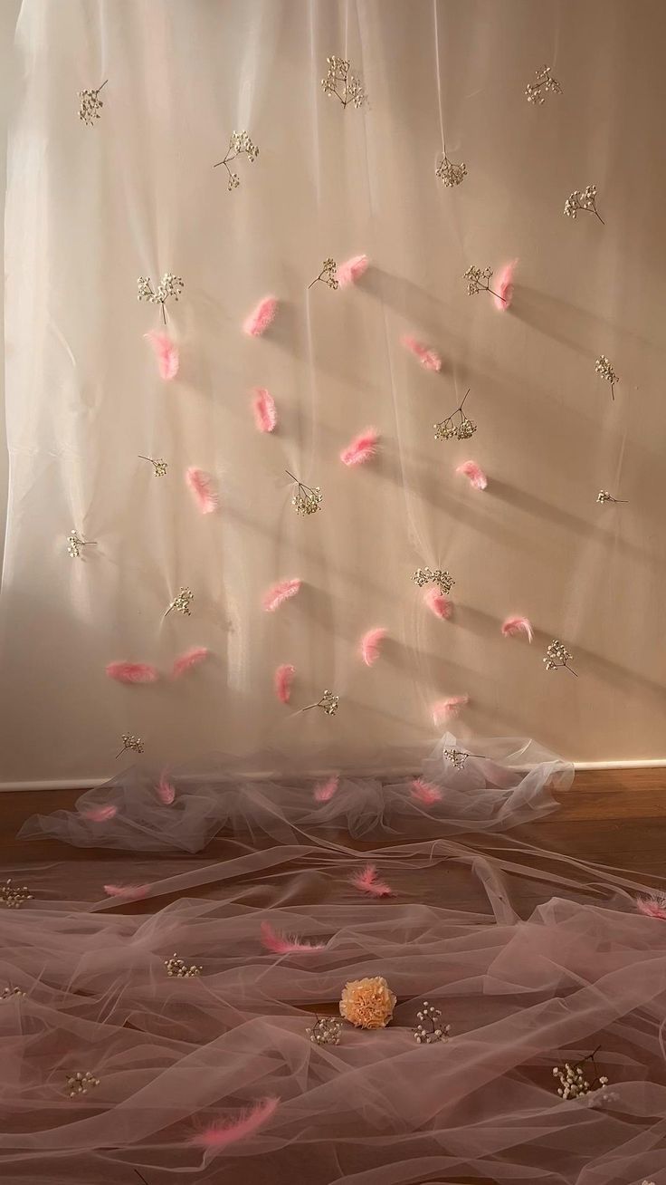 a white curtain with pink flowers on it