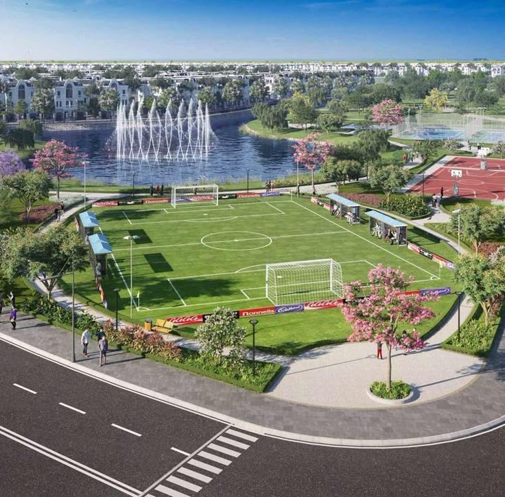 an aerial view of a soccer field with fountains in the background