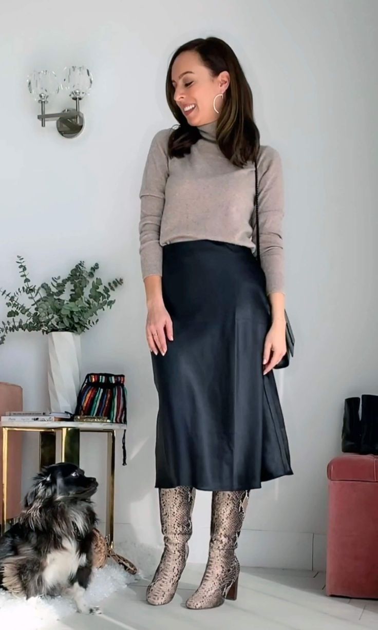 See how to wear a black slip skirt with a turtleneck and boots... 9 more outfit ideas on SydneStyle.com! @sydnesummer #slipskirt #blackskirt #midiskirt #boots #snakeskin #turtleneck Navy Slip Skirt Outfit Winter, What To Wear With A Black Satin Skirt, Midi Slip Skirt Outfit Fall, Slip Skirt Boots, Black Satin A Line Skirt Outfit, Black Skirt Black Sweater Outfit, Ways To Style A Black Skirt, Silk Slip Skirt Outfit Winter, Black Slip Skirt Outfit Fall