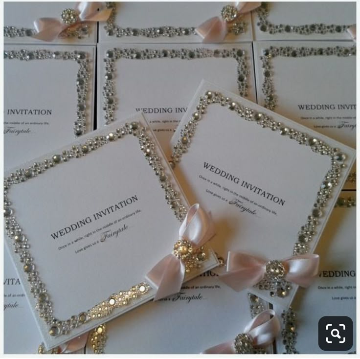 the wedding stationery is laid out on top of each other with ribbons and bows