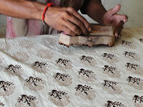 a man is working on an old piece of wood that has been turned into a tablecloth