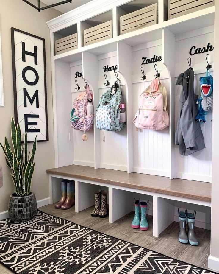 the entryway is decorated with white cubbys and coat racks