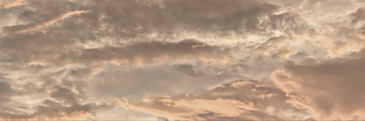 an airplane is flying through the cloudy sky