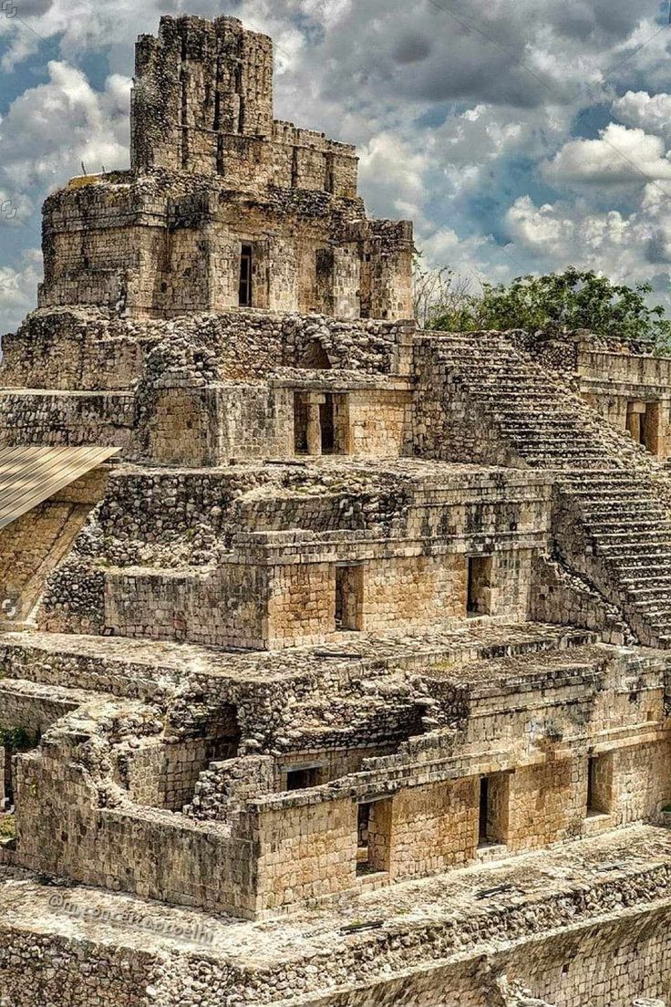 an ancient building in the middle of a cloudy sky