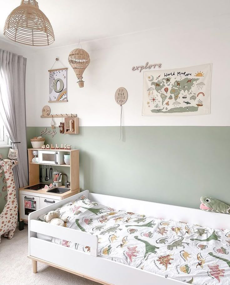 a child's bedroom with green and white walls