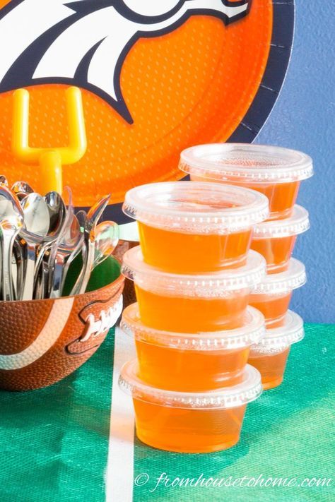 a football themed party with orange cups and silverware