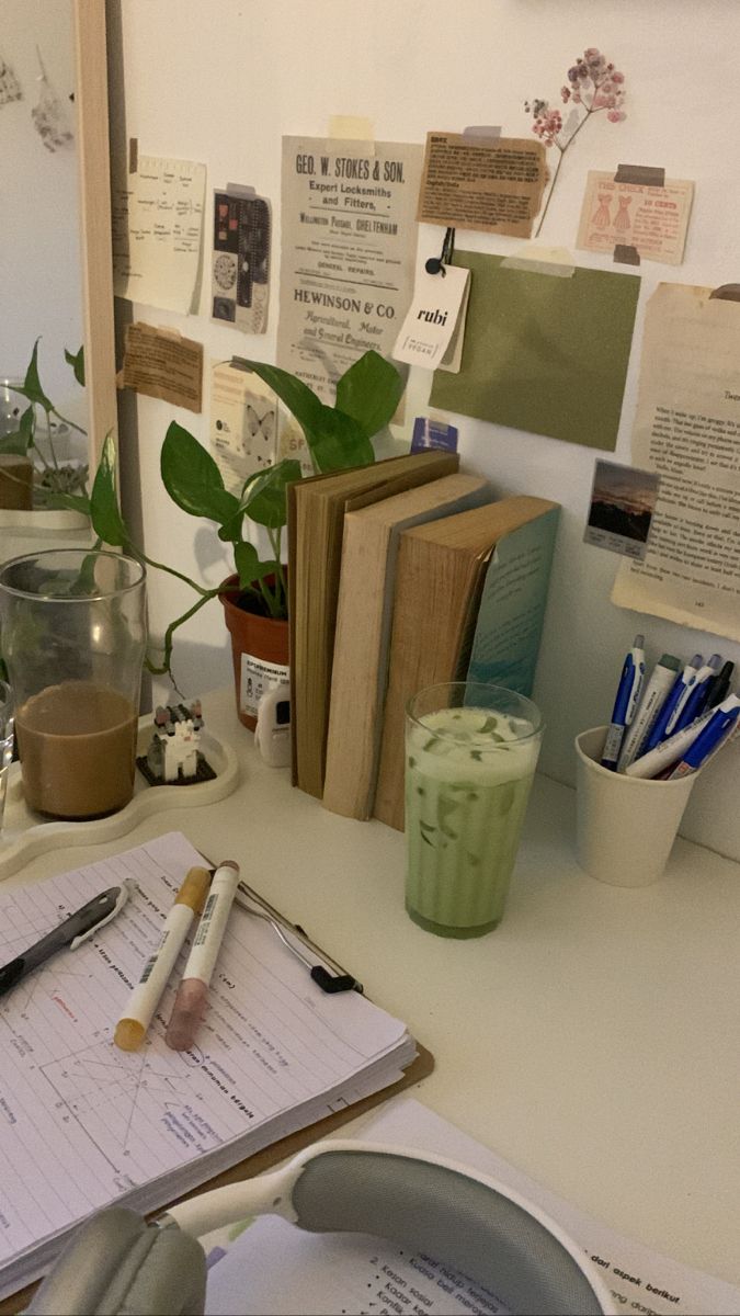 the desk is cluttered with papers and pens