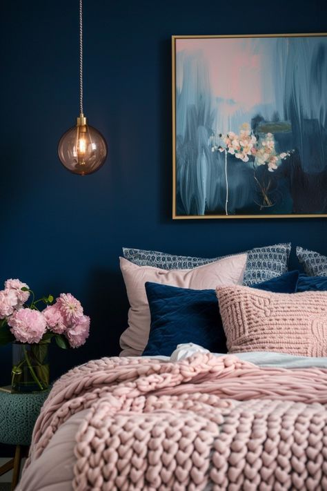 a bedroom with blue walls, pink bedding and flowers in vases on the floor