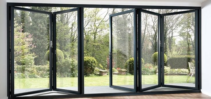 an open room with sliding glass doors on the outside and wood flooring in front of it