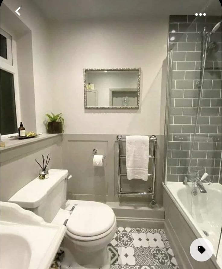 a white toilet sitting next to a bath tub