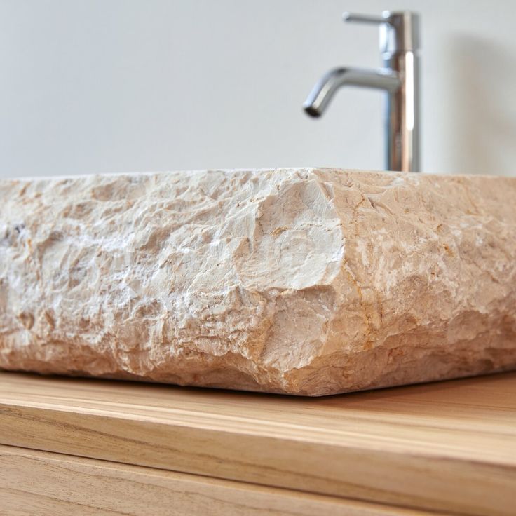 a large rock sitting on top of a wooden counter next to a faucet