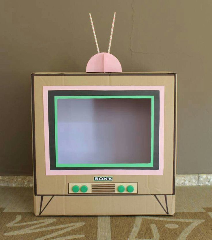 a cardboard tv sitting on top of a carpet