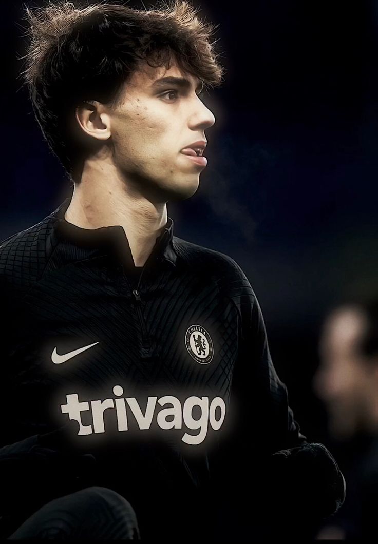 a young man in a black soccer uniform