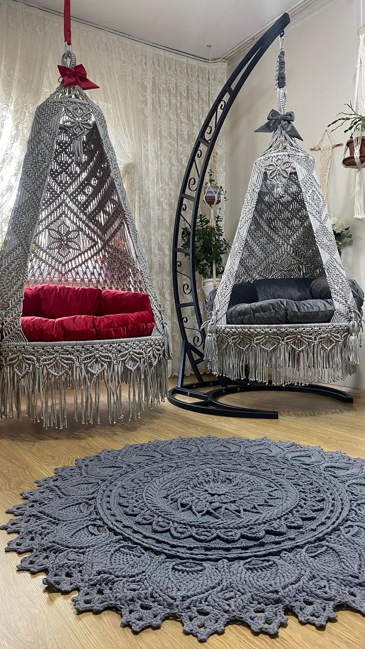 two hanging chairs and a rug on the floor