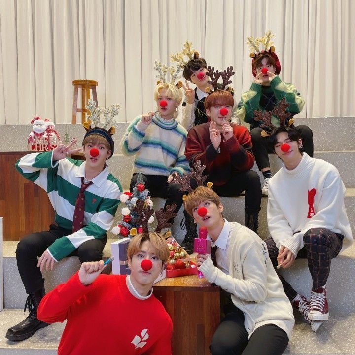 group of people dressed up as clowns sitting on steps with their noses covered in fake animals