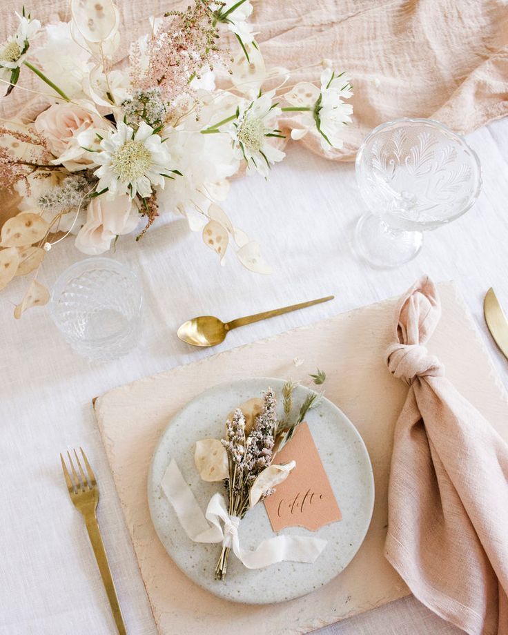 a place setting with flowers and napkins