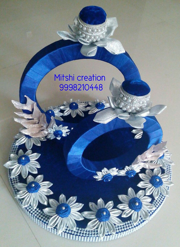 a blue and white cake with flowers on it