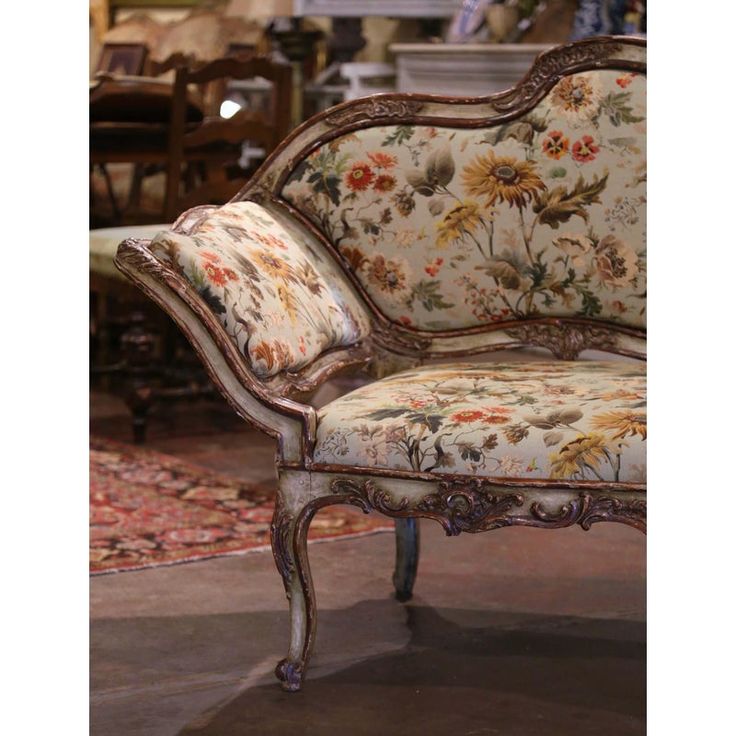 an ornately decorated chair sits in the middle of a room filled with furniture and rugs