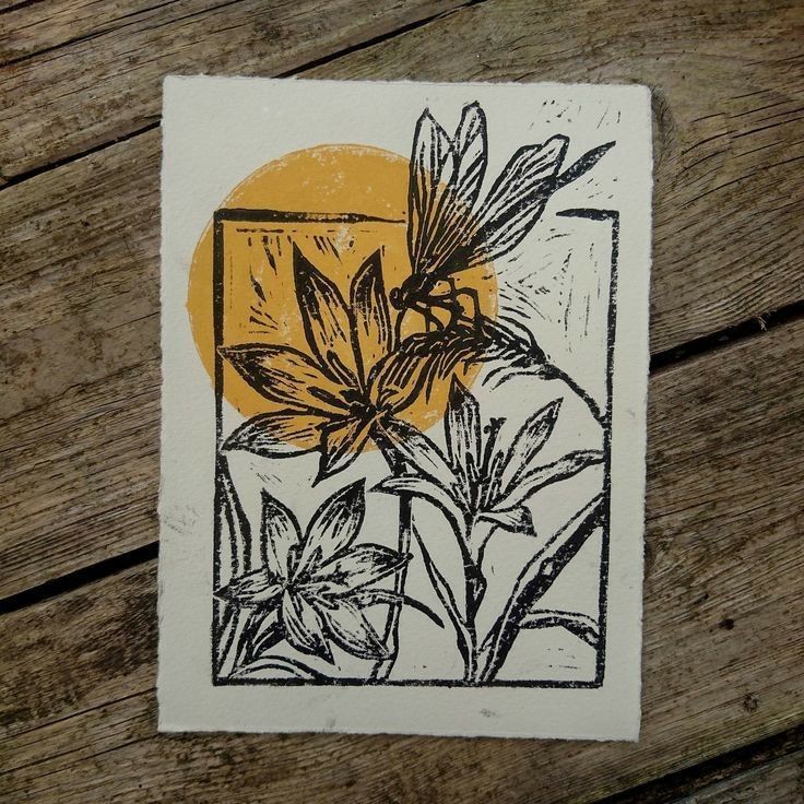 an image of a flower on a piece of paper that is sitting on a wooden surface