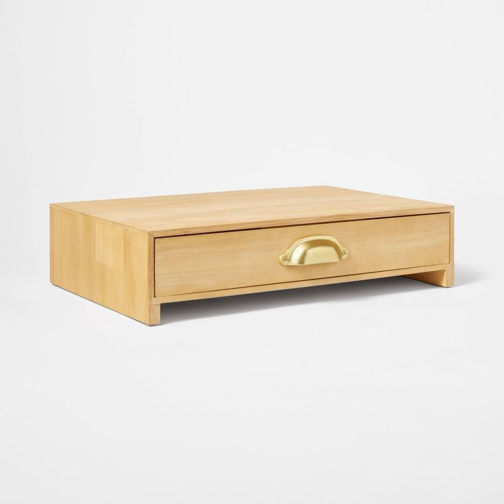 a wooden box with a gold handle on the top and bottom, against a white background