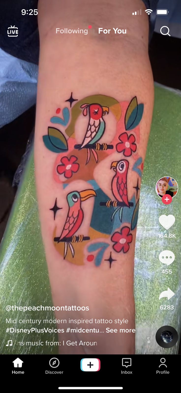 a person with a bird tattoo on their arm and the number two is painted on it