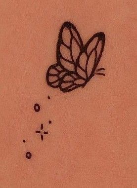 a drawing of a butterfly on the back of a woman's stomach, with bubbles coming out of it