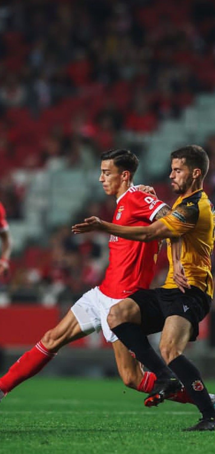 two men are playing soccer on the field