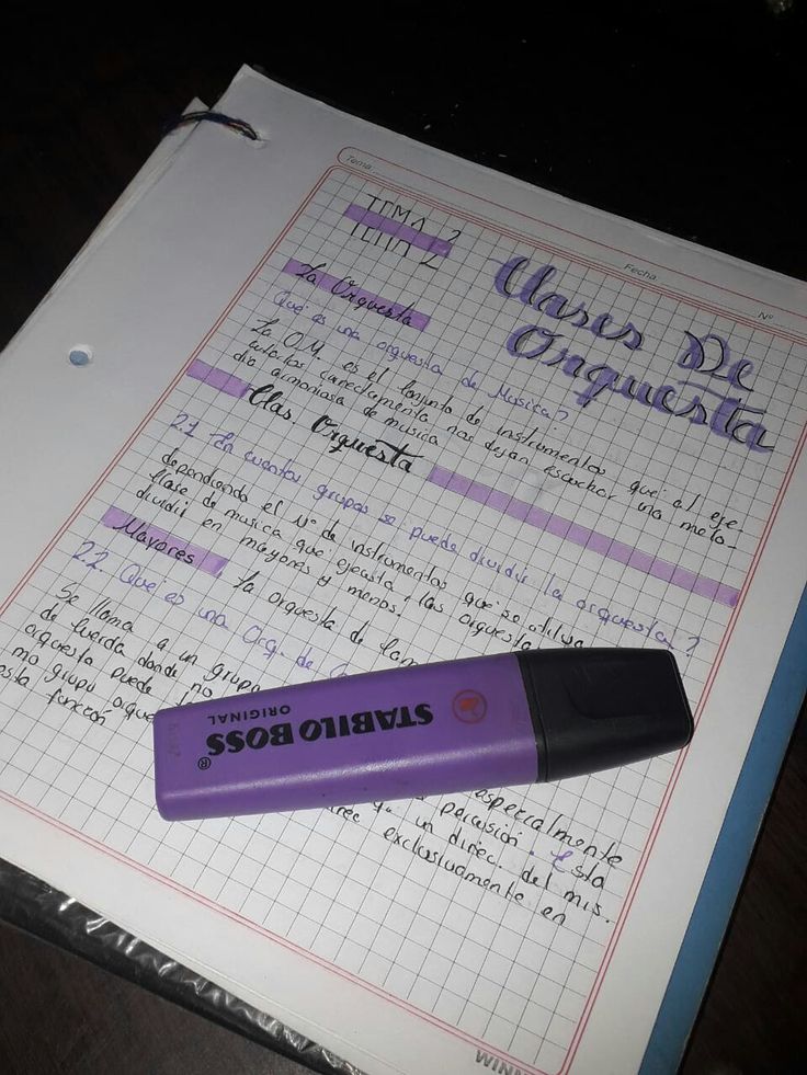 a purple pen sitting on top of a piece of paper next to a calculator