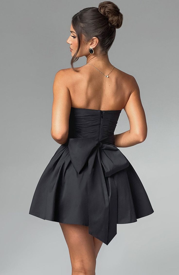 THE dress of the season has landed and you're going to be obsessed. Meet Katrina, our dreamy mini with a pretty, voluminous skirt and waist cinching bodice. Fastening with a zip to the back, tie with an oversized bow to complete the look for perfect feminine drama. 



Colour: Black.

Premium non-stretch cotton blend fabric.

Fully lined.

Strapless ruched bodice with boning.

Waist cinching.

Oversized tie to create bow detail to back.

Voluminous skirt with tulle lining.

Zip fastening to the Babyboo Dress, Voluminous Skirt, Split Long Dress, Loungewear Dresses, Maxi Dress Sale, 17th Birthday, Black Short Dress, Full Circle Skirts, Maxi Dress Navy