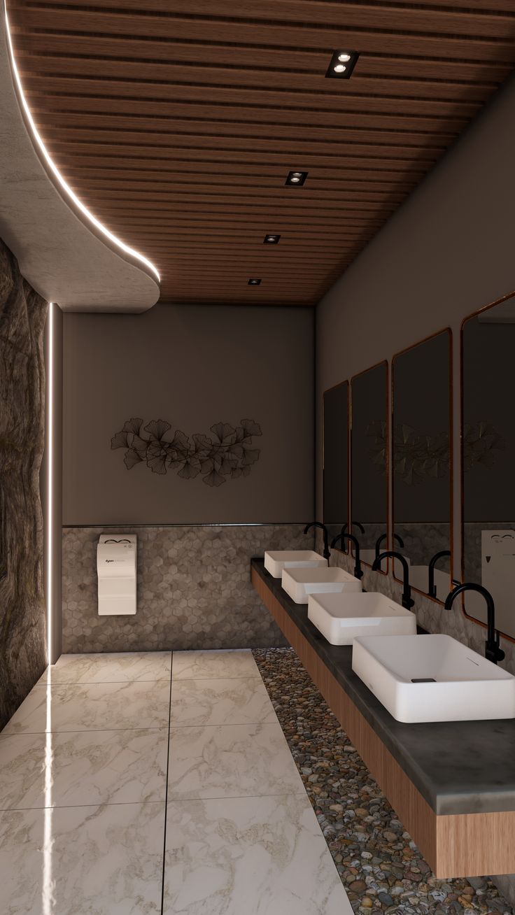 a row of sinks in a bathroom with marble counter tops and wooden ceiling above them