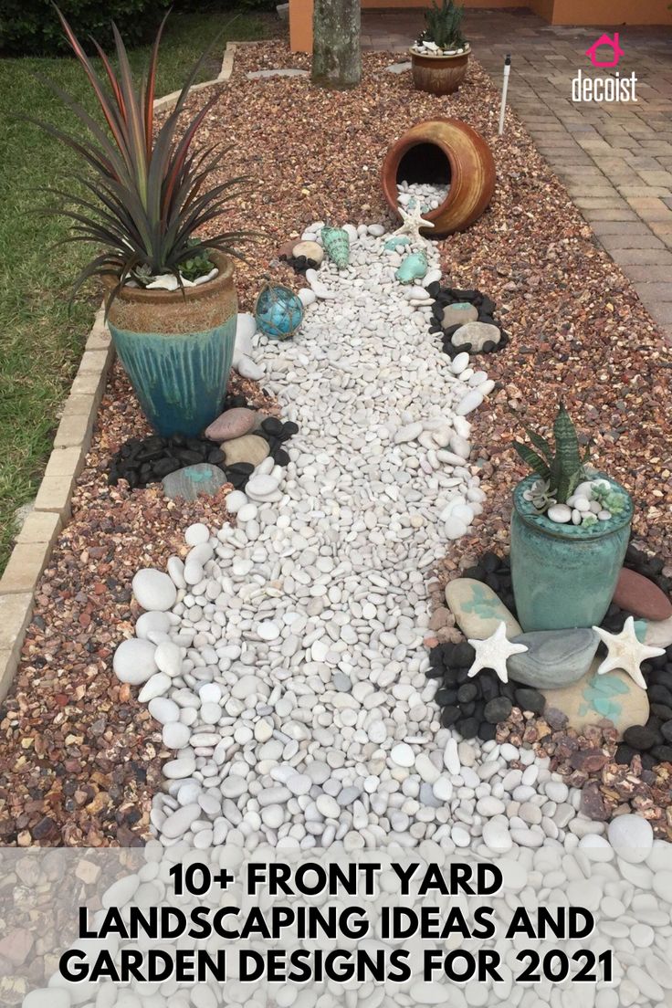 a garden with rocks, gravel and plants in the middle of it on a patio